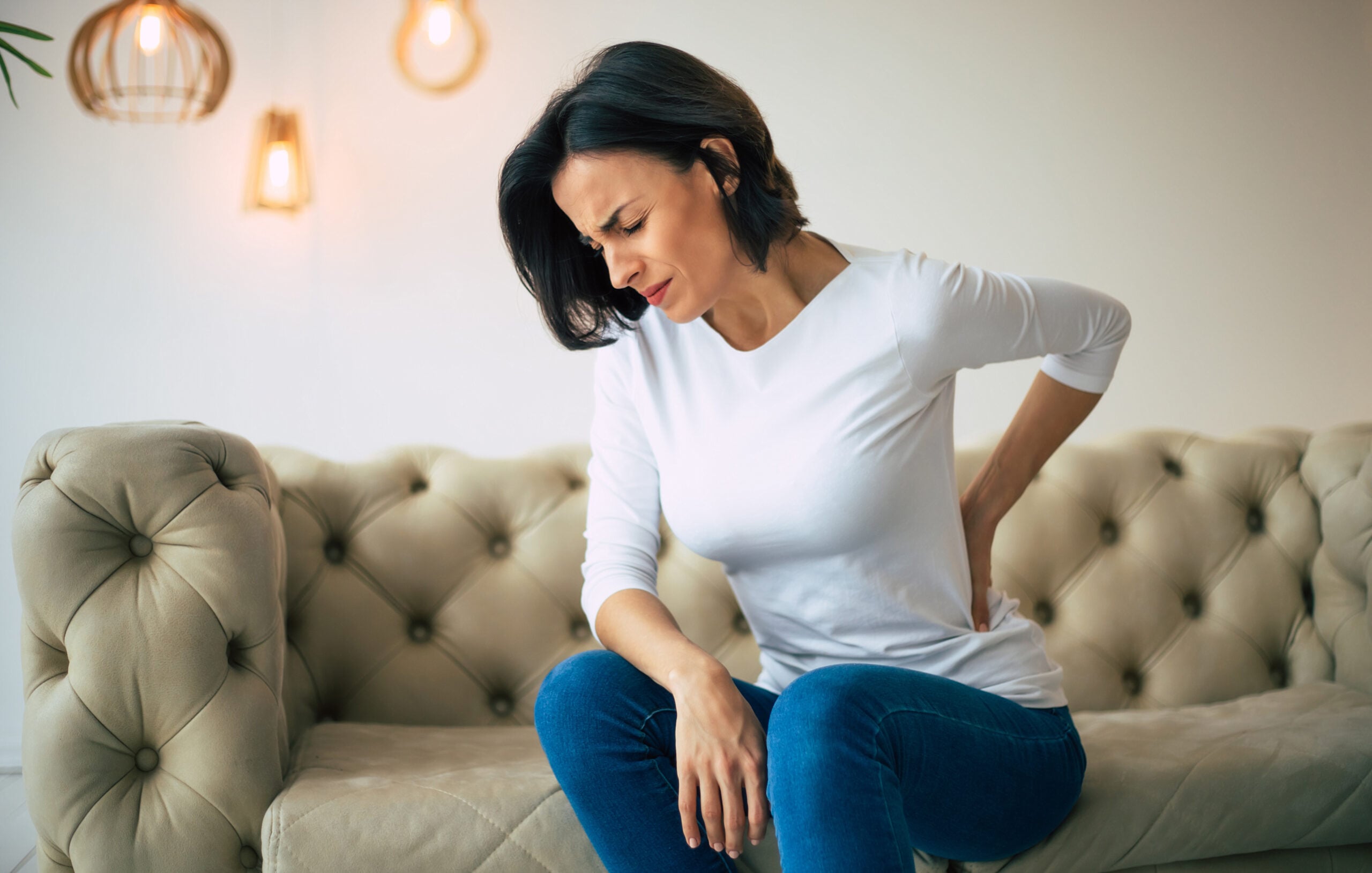 Person with chronic back pain requiring comprehensive treatment in Campbell chiropractic clinic