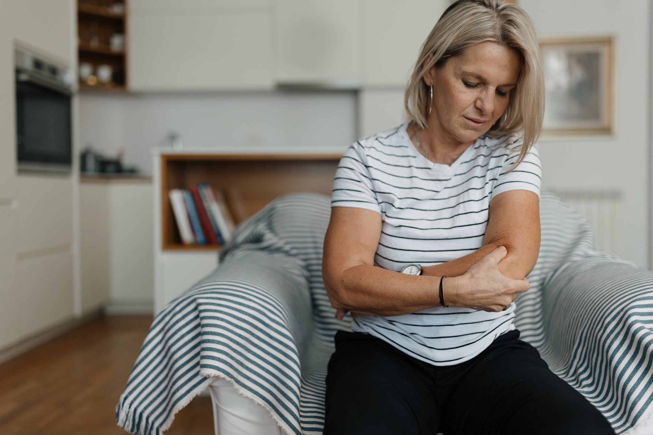 Person with elbow pain requiring specialized chiropractic treatment in Campbell