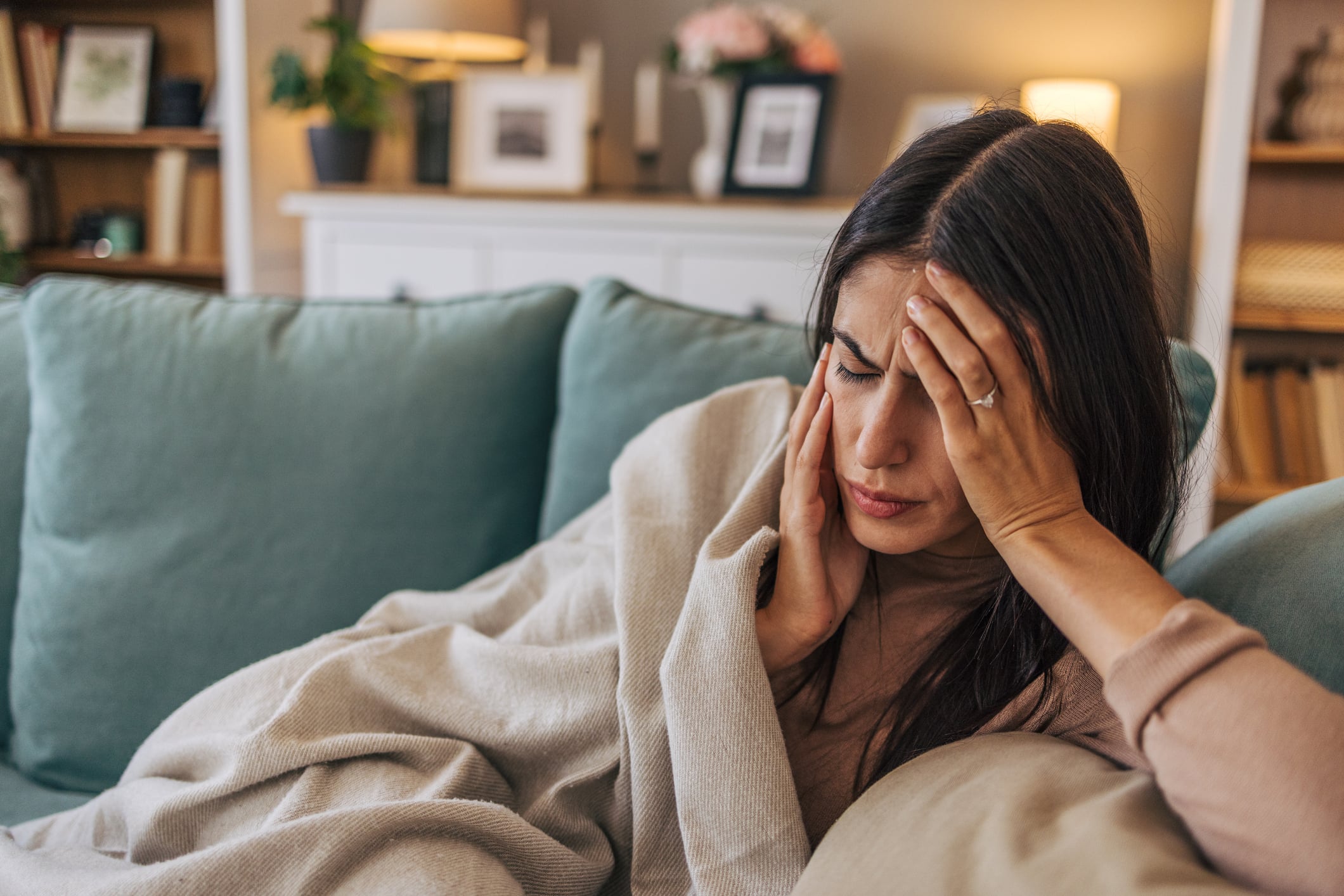 Person suffering from headache migraine pain needing treatment in Campbell chiropractic clinic