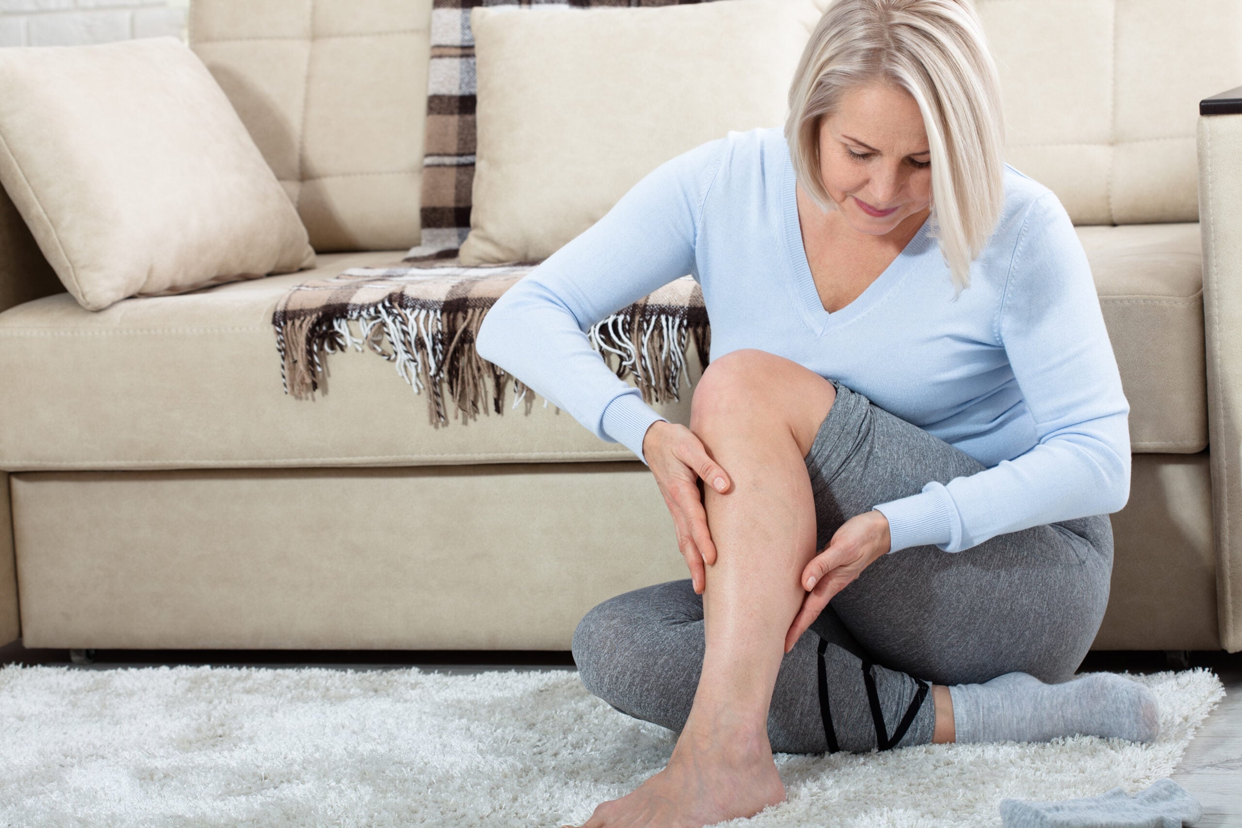 Person with leg pain requiring chiropractic treatment in Campbell clinic